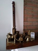Photo of various brass collectibles including swan candle holders, turtle figurine, smaller brass candle holders, and 18-inch butane fire lighter.