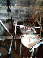 Photo shows metal framed commode and adjustable shower stool with rubber-tipped legs.