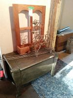 Wooden storage box topped with oak hanging shelf and metal reindeer, showing size and condition of items.