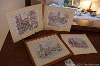 Four prints featuring Suffolk scenes, one framed in wood and three with cream mats, arranged together with a small easel.