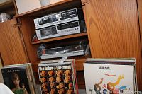 Shelf displaying two silver Sony components above the turntable and vinyl records below
