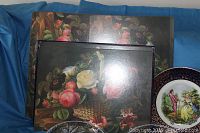 Pimpernel placemats with floral basket design stacked with other placemats