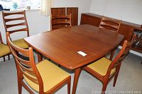 Overhead view of teak table surrounded by six chairs