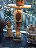 Full view of marble plant stand showing shape, size and setting with a plant on top (not included)