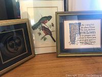 Full view of all three framed prints including the moon print, bird print, and religious scripture print