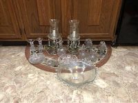 Full lot arranged on floor showing candlesticks, dishes, and bottles