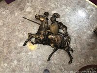 Fiberglass knight and horse wall sculpture laid flat on floor showing full body and details