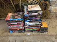 Stack of DVDs and Blu-rays along with two unopened Kodak printer ink boxes.