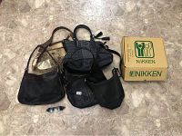 Lot of purses, Nikken shoe box, Ray-Ban sunglasses arranged on floor