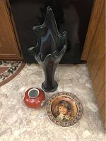 Photo showing large dark translucent fluted art glass vase with unique irregular wavy edges, tall at about 28 inches, accompanied by the orange Noritake flower vase and the Delft dish on floor