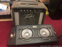 Photo of vintage Peavey Roadmaster amplifier with mesh grille and logo.
