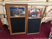 Two framed bar mirrors shown front side, one with Busch logo and the other with Budweiser logo, both with chalkboard panels below mirrors.