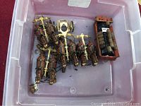 Top-down view of six brown cast iron horses with harness bars and driver figurine in wagon