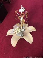 Full view of the floral chandelier showing the large flower base and metal rose accents