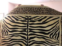 Full view of the area rug showing the zebra print in the center and leopard print on the border.