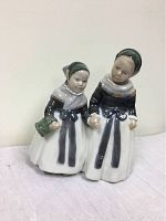 Front view showing two girls in traditional Amager dress holding hands, one holding a basket.