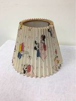 Full view of pleated fabric lamp shade with Mickey Mouse and other Disney character illustrations.