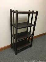 Front view of the vintage oak bookcase showing four shelves and visible surface wear and age marks.