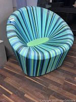 Front view showing radial striped upholstery and central cushion