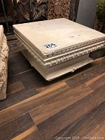 Top and side view of a square concrete pedestal showing rounded bead molding decoration on the sides and solid top surface.