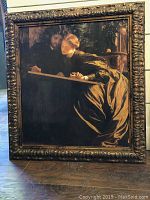 Framed giclee canvas print of a couple by Frederic Lord Leighton, displayed on floor showing front view