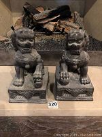 Front view of both foo dogs on hearth showing overall shape and scale