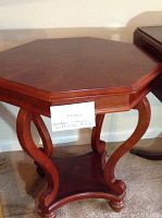 Front view of octagonal table showing tabletop and curved legs