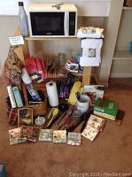 Wide view of lot showing microwave, utensils, towels, napkins, jars, and tablecloths