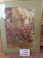 Full view of the framed print showing the geraniums, figure, and watering cans on steps.