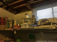 Photo of storage shelf with Braun meat slicer, plastic cutlery trays, cups, napkins and food wraps