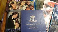 Close-up photo showing a hardbound book titled 'Elizabeth and Philip' by Louis Wulff D.V.O. and other books about the Royal Family including one with Prince Philip on the cover.