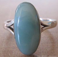 Front close-up of oval larimar cabochon stone mounted in sterling silver ring