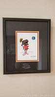 Framed Chuck Jones signed art print featuring Marvin the Martian holding a paintbrush and palette with Earth in background