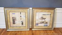 Pair of large island themed framed prints side by side on floor against wall, showing full square frames and artwork.