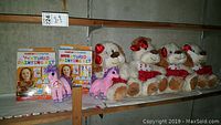 Photo showing 2 Beanie Baby unicorn plush toys, 4 Martha Stewart squeaking dog plush toys with red polka dot scarves, and 2 boxed textured painting kits.