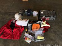 Lot contents showing toolbox, Red Cross jacket, safety vest, helmet, gloves, flashlight, hats, and various small items.