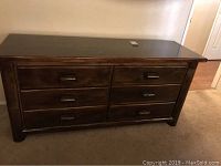 Front view of a lodge pole pine dresser showing the full six drawer layout and dark brown finish.