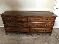 Full front view of dresser showing six drawers and overall condition including surface scratches.