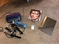 Full lot display showing Kevin Aucoin book, scalp massager, curlers, flat iron, and part of the metal mirror.