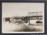 Full image of the vintage black and white photograph showing the collapsed Point Ellice Bridge with debris in water.