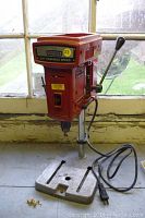Front view of the red Craftsman 3/8" variable speed tabletop drill press showing the entire unit including base, power cord, and control handle.