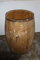 Front view of vintage wooden barrel with visible age stains and no top