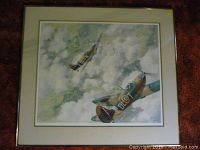 Framed print showing artwork of two WWII fighter planes in a cloudy sky.