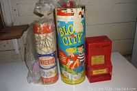 Overview of three vintage toys: Tinkertoy set, Block City kit, and Little Gum Vendor gum machine.