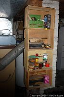 Photo of wooden shelving unit with multiple shoe shine brushes, tins of polish, and applicators.