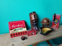 Front view showing all items from coffee grinder to Ritz cracker tin