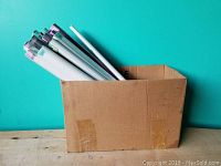 Box containing 20 rolled vintage posters with pastel colored end caps