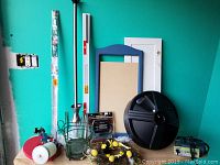 Photo showing varied home and garden items including curved shower curtain rod, umbrella base, window blinds cut to fit, cabinet door, mirror surround frame, and plant holders.