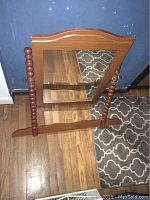Front view of wooden framed dresser mirror with spindle sides and mirror glass.