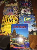 Photo showing front covers of 7 books: 6 I Spy books and 1 Look-Alikes book.